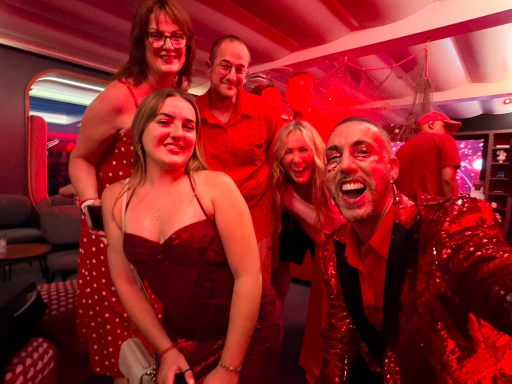 Travelers at a red-themed party